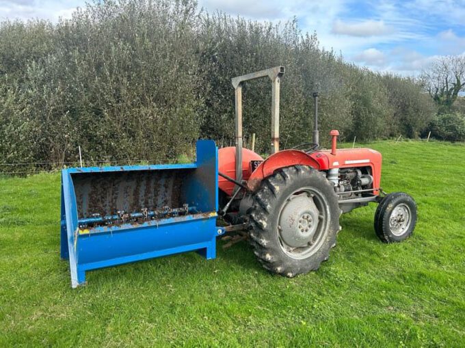 Fleming mini-muck compact muck spreader attached to a small tractor