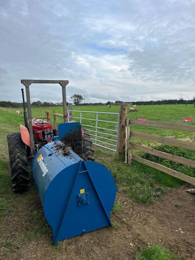 Fleming mini-muck compact muck spreader attached to a small tractor