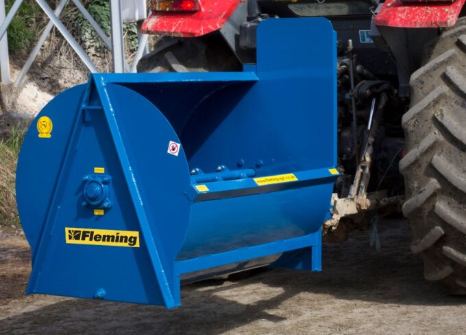 Fleming mini-muck compact muck spreader attached to a small tractor