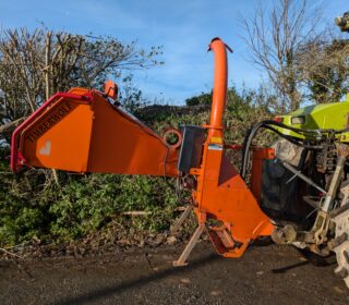 Tractor-mounted wood chipper by Timberwolf