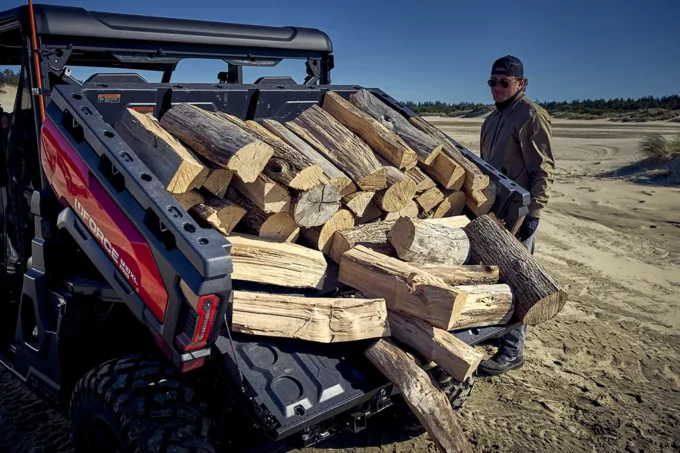 Tipping out logs from the cargo bed of a CFMOTO U10 PRO XL utility vehicle
