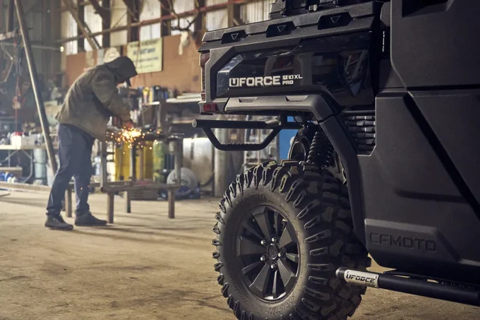 Rear end of CFMOTO U10 PRO XL with man welding in the background